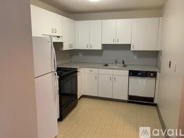Waterbury apartment for rent - A kitchen with white cabinets and appliances.