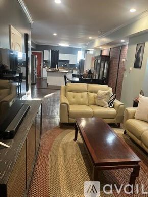 Indianapolis townhouse for rent - A living room with a couch, a coffee table, and a television.