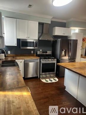 Indianapolis townhouse for rent - A kitchen with a wooden counter top and stainless steel appliances.