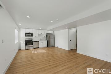 Lehi apartment for rent - A kitchen with white cabinets and a wooden floor.