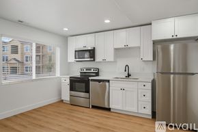 Lehi apartment for rent - A kitchen with white cabinets and stainless steel appliances.