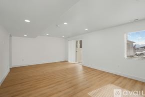 Lehi apartment for rent - A spacious room with wooden flooring and white walls.