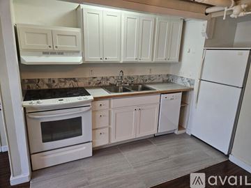 St. Helens apartment for rent - A kitchen with white appliances and cabinets.