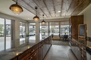 Greenfield apartment for rent - A modern kitchen with wooden cabinets and a large island.