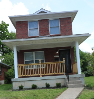 Louisville house for rent - A red brick house with a white porch.