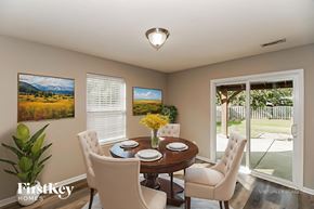 Midland house for rent - A dining room with a table set for two and a painting of a mountain scene on the wall.