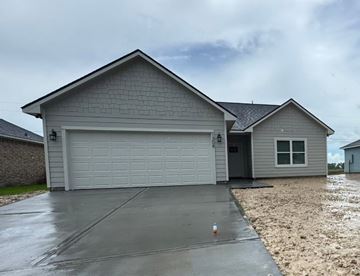 Bay City house for rent - A house with a grey garage door and a grey roof.
