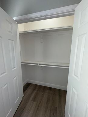 Bay City house for rent - A white closet with a wooden floor and white walls.