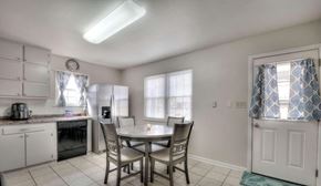 Rome house for rent - A kitchen with a table and chairs in front of a window.