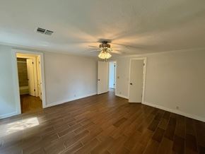 Oklahoma City apartment for rent - A room with wooden flooring and a ceiling fan.