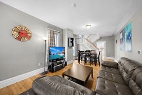 Columbus house for rent - A living room with a brown leather couch and a flat screen TV.