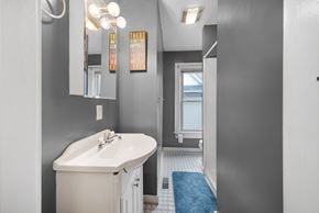Columbus house for rent - A bathroom with a white sink and a blue rug.