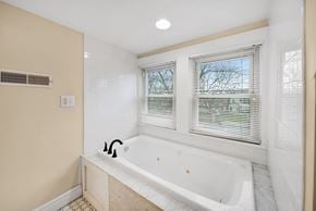 Columbus house for rent - A white bathtub with a window above it in a bathroom.