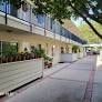 Burbank apartment for rent - A long building with a balcony and plants on it.