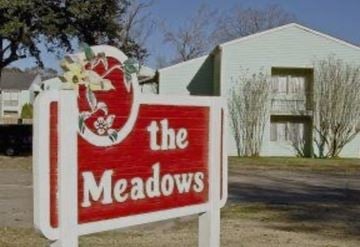 Lafayette apartment for rent - A sign for "The Meadows" is shown in front of a building.