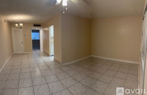 Lantana apartment for rent - A room with a ceiling fan and a mirror on the wall.