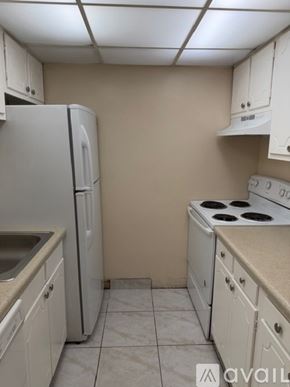 Lantana apartment for rent - A kitchen with white cabinets and a countertop.