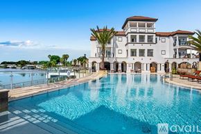 Tampa apartment for rent - A large white house with a pool in front.