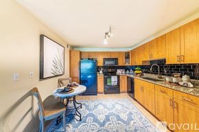 Tampa apartment for rent - A kitchen with a blue refrigerator and a dining table with chairs.