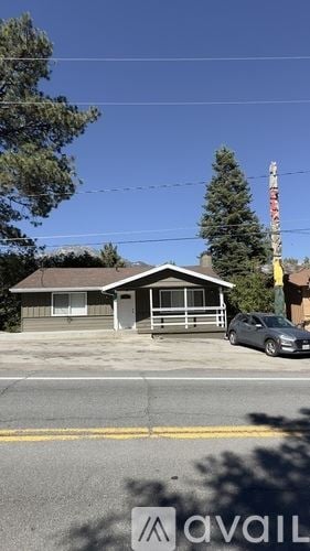 Idyllwild Pine Cove house for rent - A house with a grey roof and a grey car parked in front.