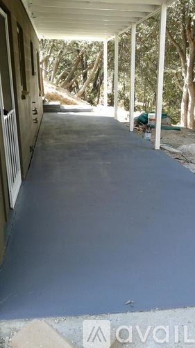 Idyllwild Pine Cove house for rent - A long covered walkway with columns on either side.