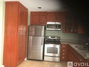 Idyllwild Pine Cove house for rent - A kitchen with wooden cabinets and stainless steel appliances.