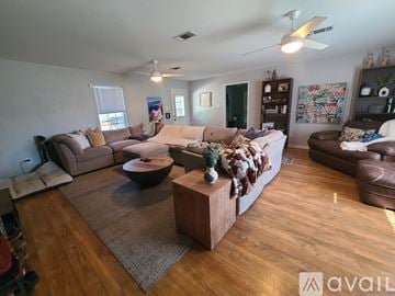 Waco house for rent - A living room with a brown sofa and a wooden coffee table.