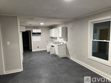 Memphis house for rent - A kitchen area with a refrigerator, microwave, and a dishwasher.