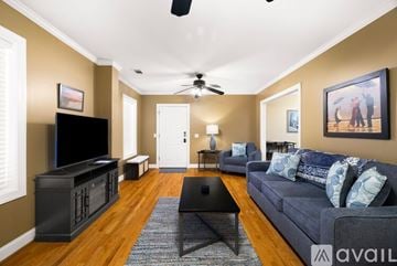 Savannah house for rent - A living room with a black television and a grey couch.
