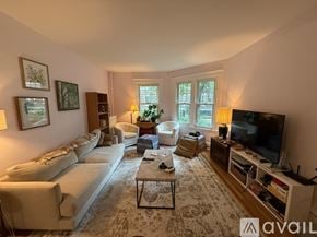 Brookline apartment for rent - A living room with a white sofa, a coffee table, and a television.