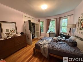 Brookline apartment for rent - A bedroom with a bed, dresser, and window with curtains.