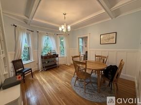 Brookline apartment for rent - A dining room with a wooden table and chairs.