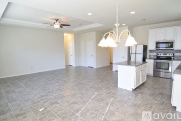 Killeen house for rent - A kitchen with a refrigerator, microwave, and oven is available for rent.