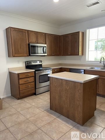 Prescott Valley house for rent - A kitchen with wooden cabinets and a white countertop.