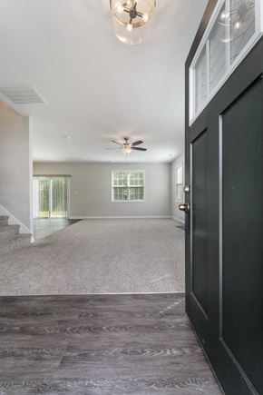 Jacksonville house for rent - A black door is on the right side of a hallway.