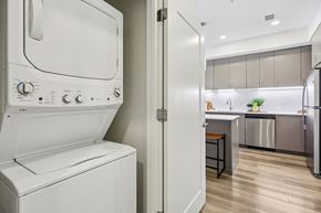 Grand Prairie apartment for rent - A white dishwasher is in a kitchen with a white oven.
