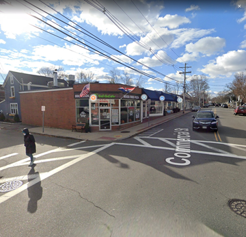 Marblehead apartment for rent - A street view with a crosswalk and a car driving on the road.