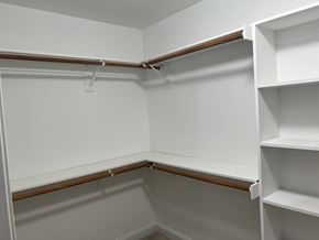 Wilson house for rent - A white walk-in closet with shelves and a wooden floor.