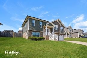 Clarksville house for rent - A house with a grey and white exterior is shown with the words "FirstKey Homes" on the bottom left.