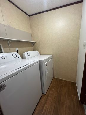 Grinnell house for rent - A small laundry room with a washer and dryer.