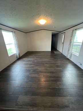 Grinnell house for rent - A room with wooden flooring and a window on the left side.
