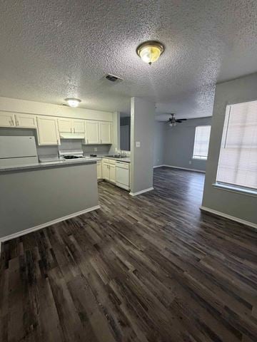 Mansfield apartment for rent - A kitchen with wood flooring and white cabinets.
