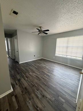 Mansfield apartment for rent - A room with a ceiling fan and wood flooring.