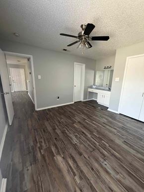 Mansfield apartment for rent - A room with a ceiling fan and wood flooring.