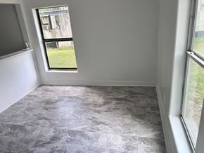Bay City apartment for rent - A room with a marble floor and a window overlooking a grassy area.