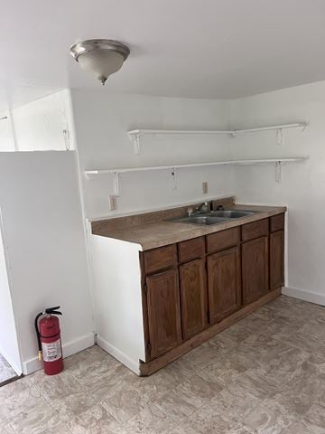 Bay City apartment for rent - A red fire extinguisher is on the floor next to a kitchen island.