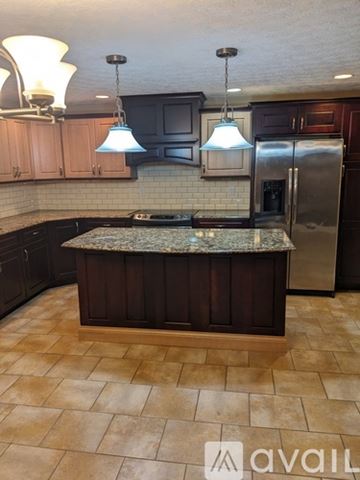 Dayton house for rent - A kitchen with a granite countertop and tile flooring.