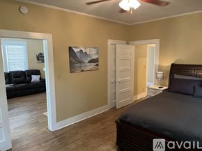 Stanton house for rent - A bedroom with a bed, a couch, and a painting on the wall.