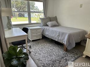 Seminole house for rent - A bedroom with a bed, desk, and chair.