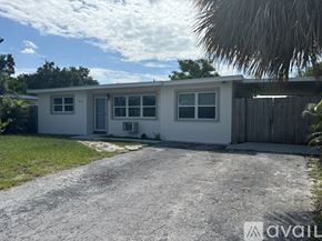 Seminole house for rent - A white house with a gravel driveway in front.